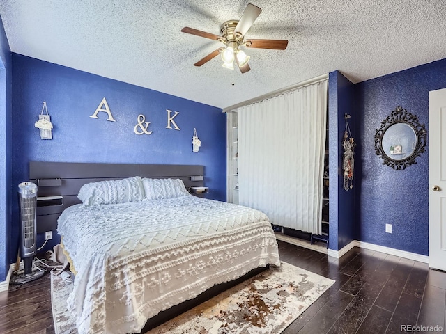 bedroom featuring a textured ceiling, ceiling fan, and dark wood-type flooring