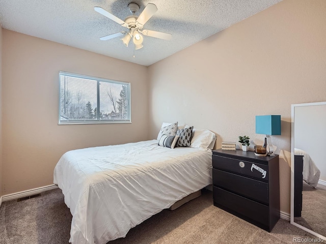 bedroom with carpet, ceiling fan, and a textured ceiling