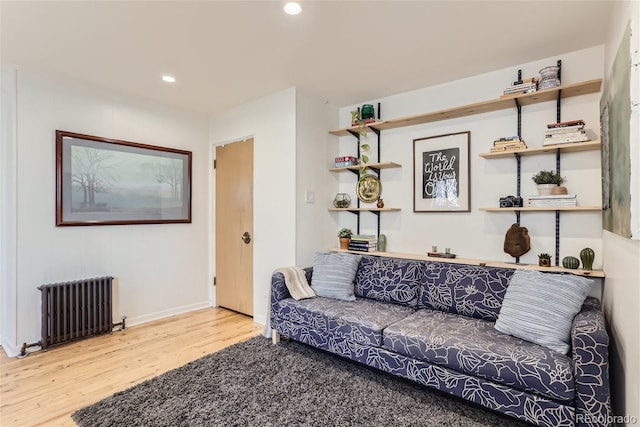 living room with hardwood / wood-style flooring and radiator heating unit