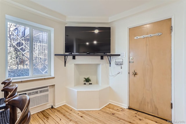 foyer entrance with plenty of natural light, light hardwood / wood-style floors, and ornamental molding