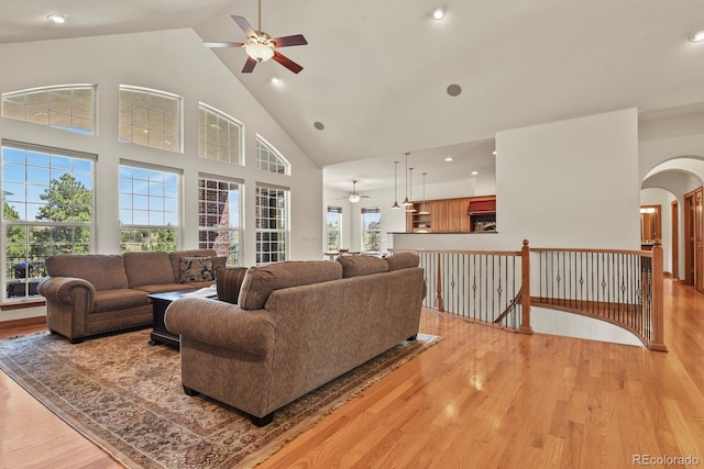 11268 Bell Cross Cir, Parker, CO 80138 - living room with a ceiling fan, light wood-style flooring, high vaulted ceiling, arched walkways, and recessed lighting