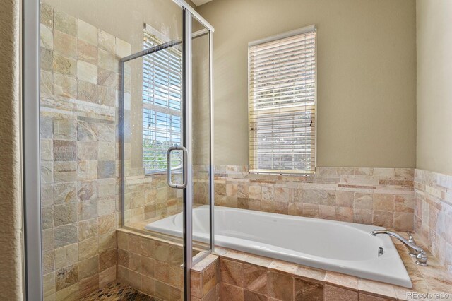 11268 Bell Cross Cir, Parker, CO 80138 - bathroom featuring a garden tub and a shower stall