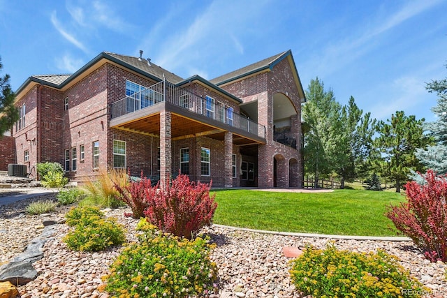 11268 Bell Cross Cir, Parker, CO 80138 - rear view of property with brick siding, a yard, and a balcony