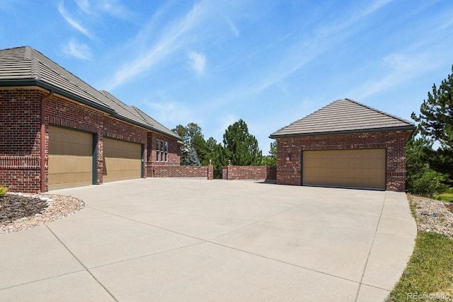 11268 Bell Cross Cir, Parker, CO 80138 - view of side of home with brick siding, a tile roof, and driveway