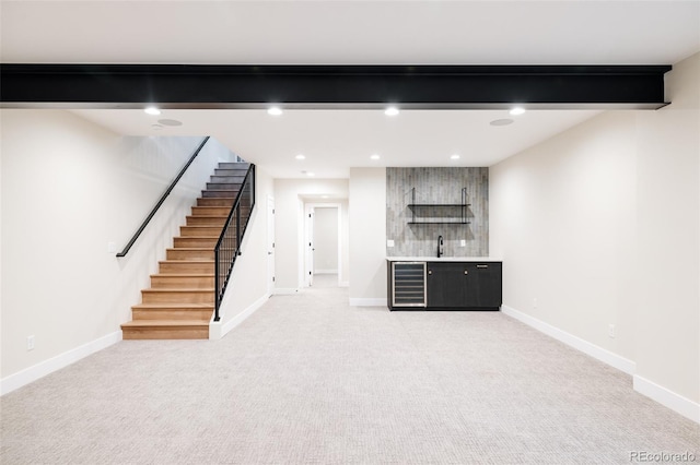 basement featuring light carpet, wine cooler, and bar