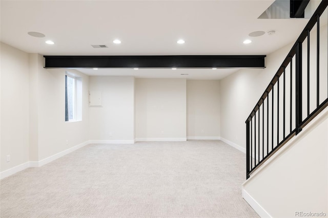 basement featuring light carpet