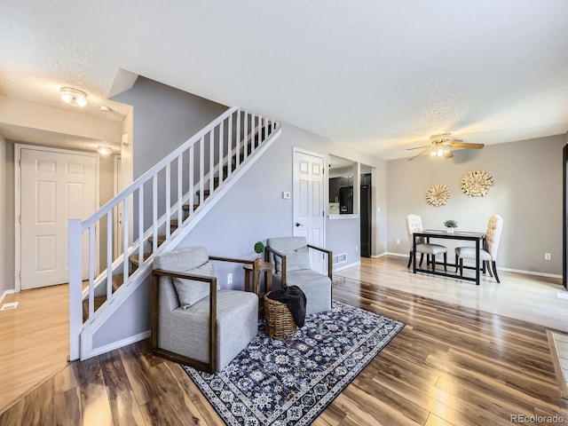 5154 E 126th Ct, Thornton, CO 80241 - living room featuring stairway, a textured ceiling, wood finished floors, and a ceiling fan