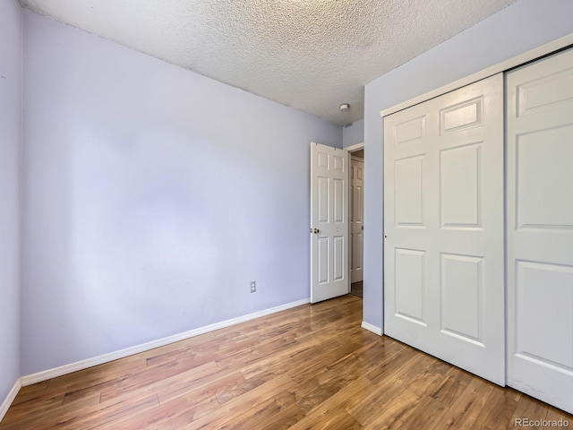 5154 E 126th Ct, Thornton, CO 80241 - unfurnished bedroom with light wood finished floors, a closet, and a textured ceiling