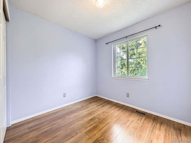 5154 E 126th Ct, Thornton, CO 80241 - unfurnished room with wood finished floors and a textured ceiling