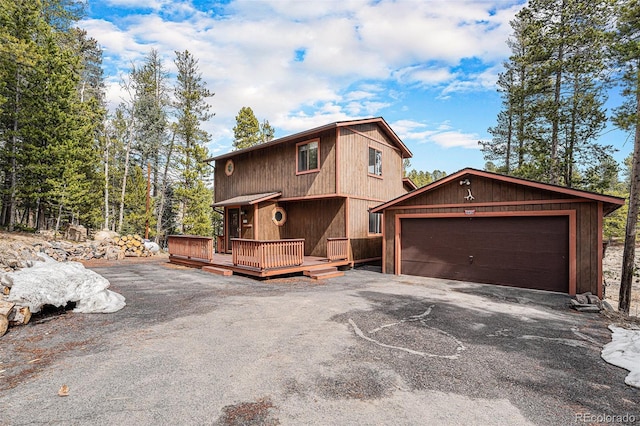 10858 Norton Ave, Conifer, CO 80433 - rustic home featuring a detached garage, a wooden deck, and an outdoor structure