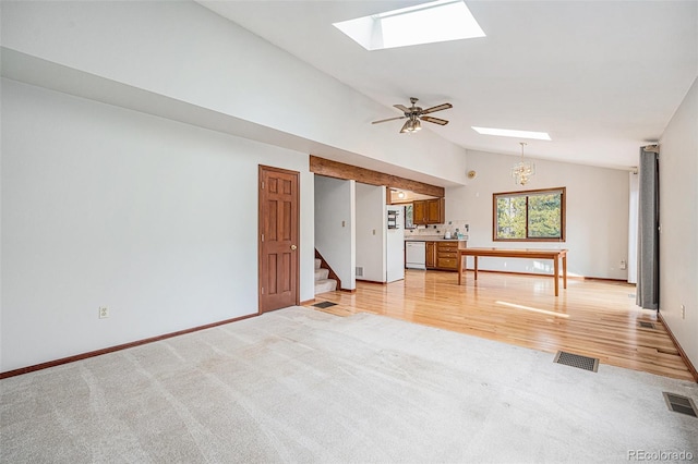 10858 Norton Ave, Conifer, CO 80433 - unfurnished living room featuring visible vents, lofted ceiling with skylight, and light carpet