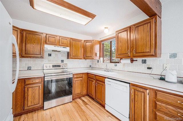 10858 Norton Ave, Conifer, CO 80433 - kitchen with white appliances, brown cabinets, under cabinet range hood, and a sink