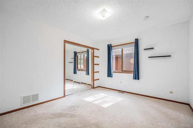 10858 Norton Ave, Conifer, CO 80433 - spare room featuring baseboards, visible vents, carpet, and a textured ceiling