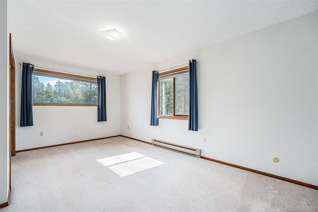 10858 Norton Ave, Conifer, CO 80433 - carpeted empty room featuring baseboards, a baseboard heating unit, and a textured ceiling