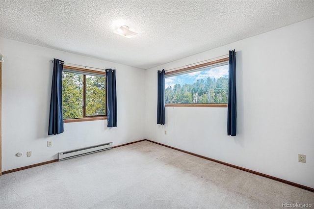 10858 Norton Ave, Conifer, CO 80433 - carpeted empty room with a wealth of natural light, a baseboard heating unit, baseboards, and a textured ceiling