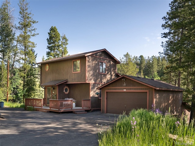 10858 Norton Ave, Conifer, CO 80433 - rustic home with driveway, a deck, and a garage