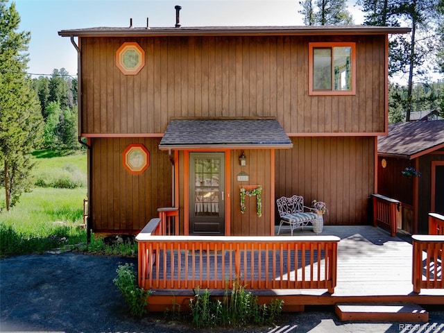 10858 Norton Ave, Conifer, CO 80433 - view of front of home featuring a deck and a shingled roof