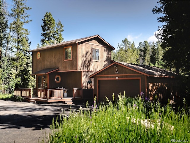 10858 Norton Ave, Conifer, CO 80433 - chalet / cabin with a deck, an attached garage, and driveway