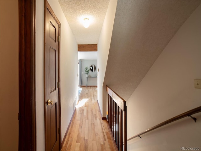 10858 Norton Ave, Conifer, CO 80433 - hallway featuring light wood-style flooring, a textured ceiling, and an upstairs landing