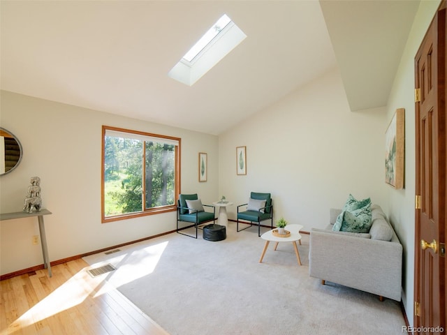 10858 Norton Ave, Conifer, CO 80433 - living area featuring a skylight, light wood-type flooring, and vaulted ceiling