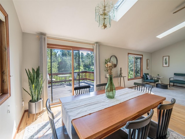 10858 Norton Ave, Conifer, CO 80433 - dining room with a skylight, lofted ceiling, healthy amount of natural light, and wood finished floors