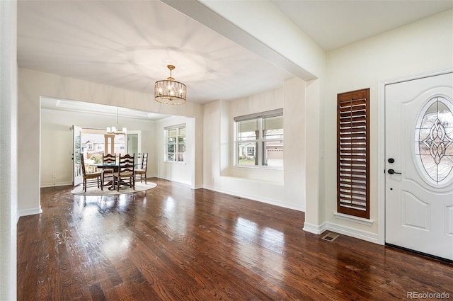 entryway featuring a wealth of natural light, dark hardwood / wood-style flooring, and a chandelier