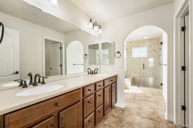 bathroom featuring vanity and a shower with door