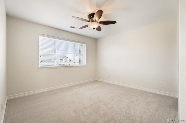 spare room featuring ceiling fan and light colored carpet