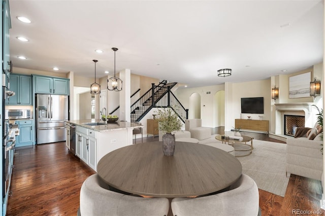 dining room featuring sink and dark wood-type flooring