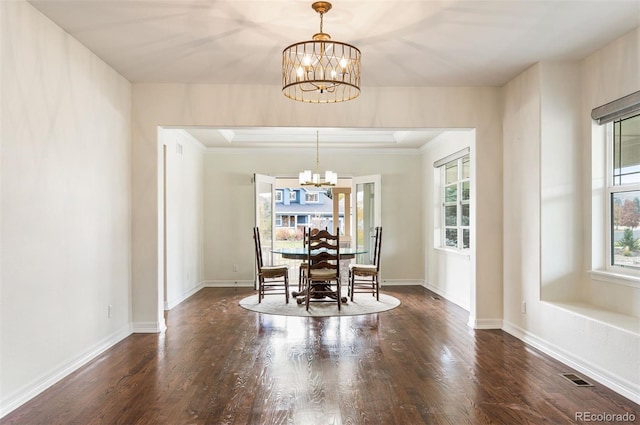 unfurnished dining area with a chandelier, dark hardwood / wood-style floors, and ornamental molding