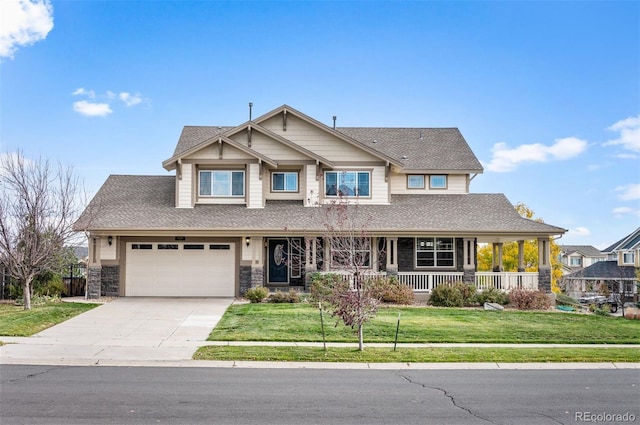 craftsman inspired home featuring a porch, a garage, and a front lawn