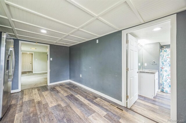 524 N 4th Ave, Sterling, CO 80751 - unfurnished room featuring wood finished floors, baseboards, and recessed lighting