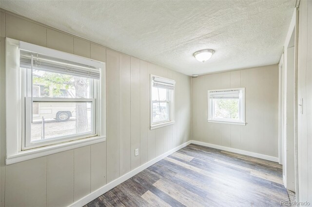 524 N 4th Ave, Sterling, CO 80751 - empty room with wood finished floors, baseboards, and a textured ceiling