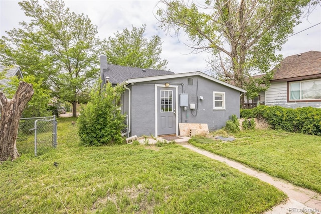 524 N 4th Ave, Sterling, CO 80751 - view of front facade featuring stucco siding, a chimney, and roof with shingles