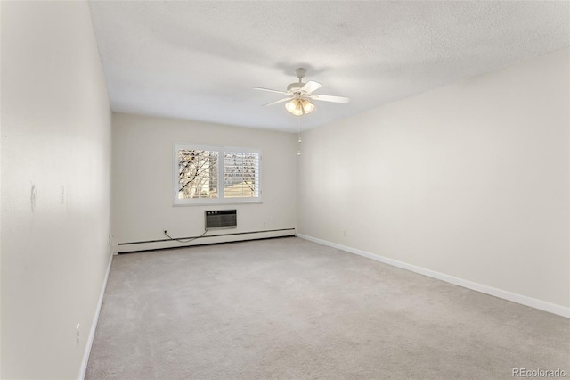 carpeted spare room with a baseboard radiator, baseboards, ceiling fan, and a textured ceiling