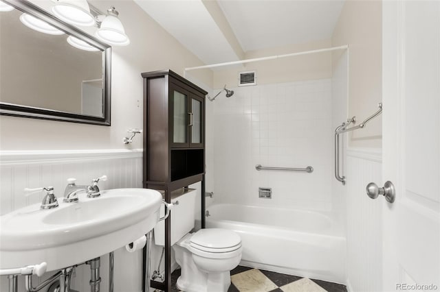 bathroom featuring a wainscoted wall, a sink, visible vents, and toilet