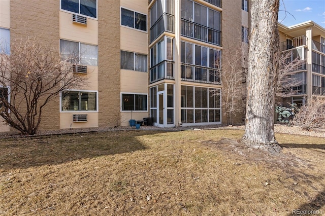 view of building exterior featuring a wall unit AC