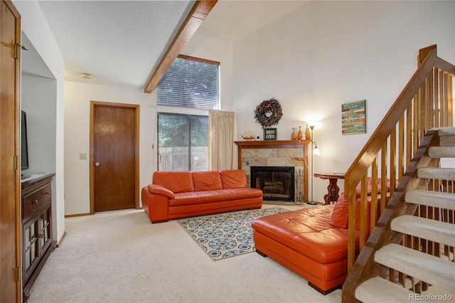 living room featuring beam ceiling, a tiled fireplace, light carpet, and high vaulted ceiling