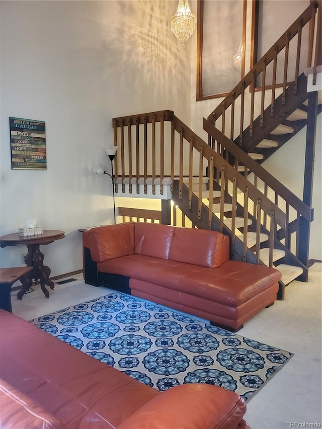 living room featuring carpet floors and a notable chandelier