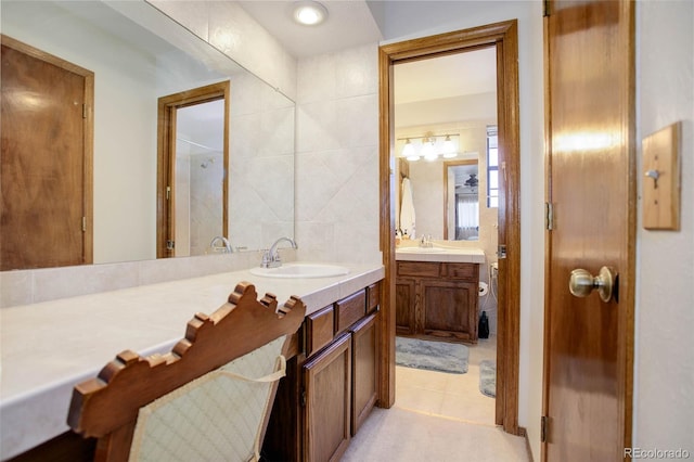 bathroom featuring vanity, tile patterned floors, and tile walls