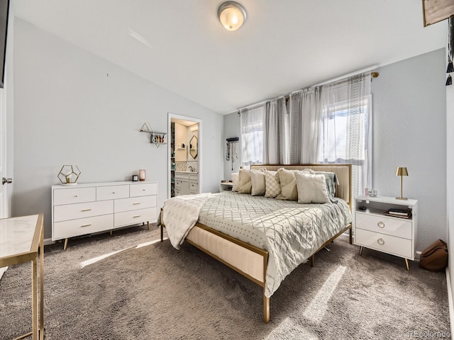 bedroom featuring carpet flooring, vaulted ceiling, and ensuite bathroom