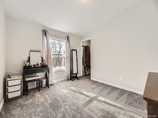 bedroom featuring carpet floors, baseboards, and lofted ceiling