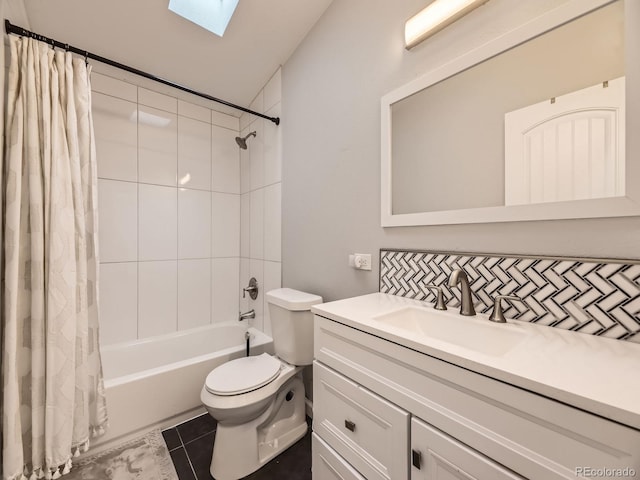 full bath with a skylight, backsplash, toilet, shower / bath combo, and vanity