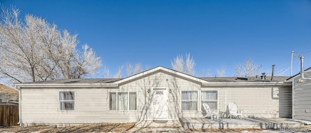 rear view of property with a patio area and fence