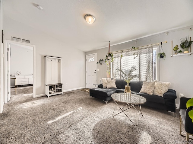 living room with carpet flooring, visible vents, and baseboards