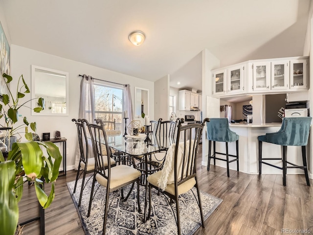 dining area featuring wood finished floors and baseboards