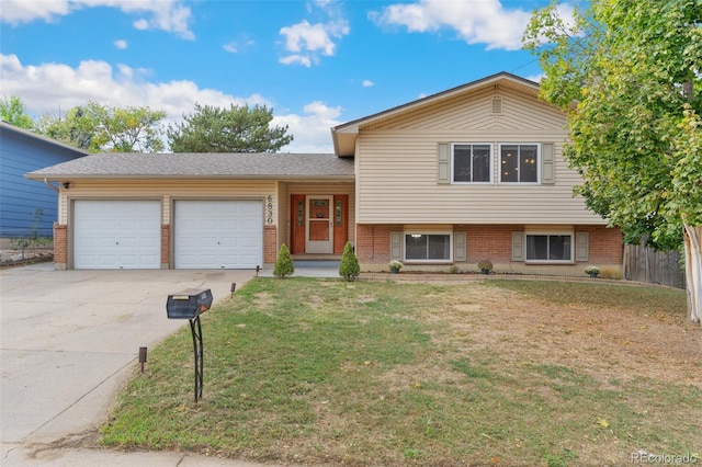 tri-level home featuring a front yard and a garage