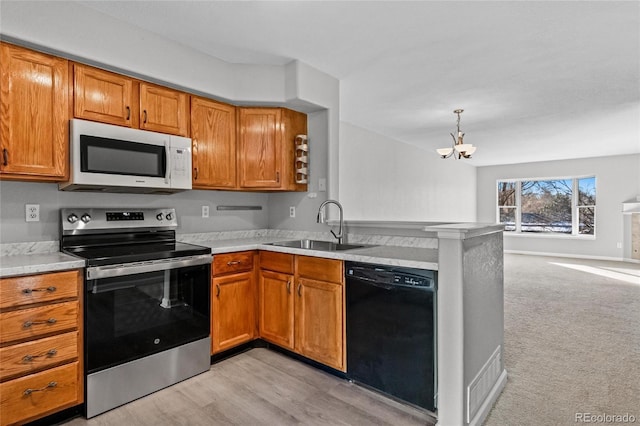 kitchen with dishwasher, sink, an inviting chandelier, kitchen peninsula, and electric stove