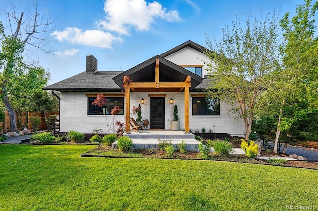 1801 Redwood Ave, Boulder, CO 80304 - view of front of property featuring brick siding, a chimney, a front lawn, and covered porch