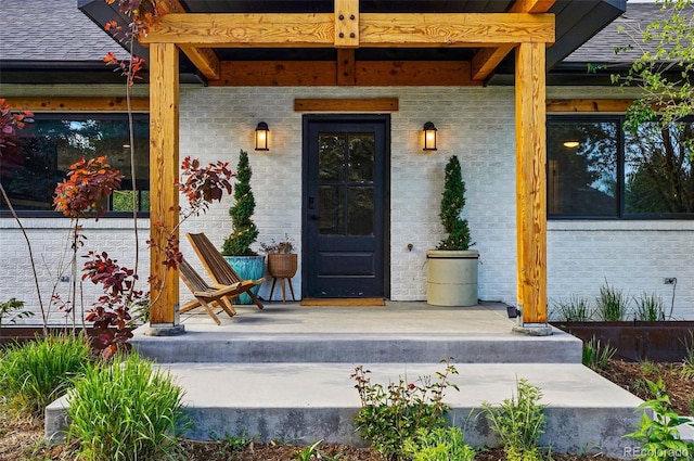 1801 Redwood Ave, Boulder, CO 80304 - property entrance featuring covered porch, brick siding, and roof with shingles